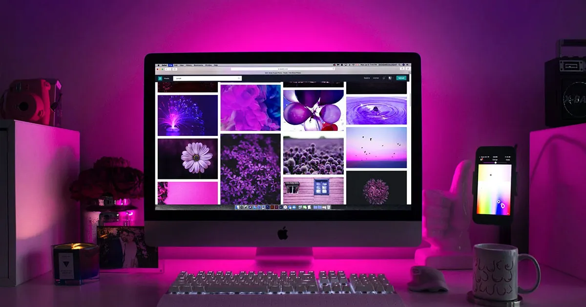 An iMac with purple lights behind and different images on the screen using the same colour. It represents the relevance of aesthetics for digital marketing.